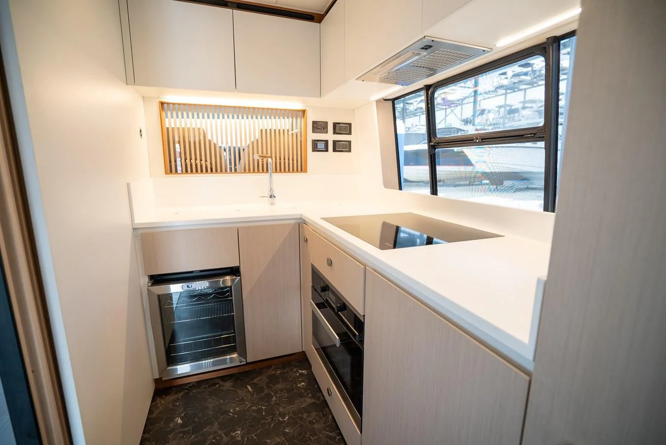 a kitchen with a stove and oven aboard 2023 AZIMUT FLY 78/56 Yacht for Sale