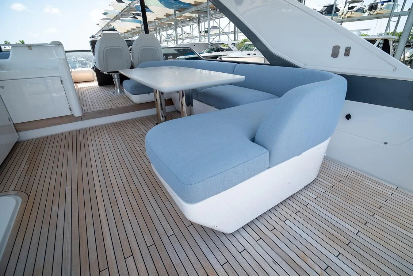 a deck with a table and chairs on it aboard 2023 AZIMUT FLY 78/56 Yacht for Sale