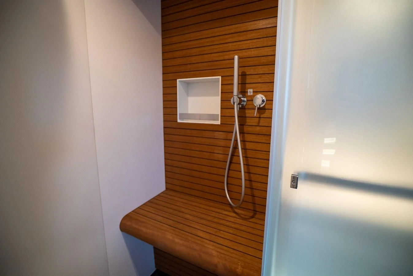 a wooden staircase with a light fixture aboard 2023 AZIMUT FLY 78/56 Yacht for Sale