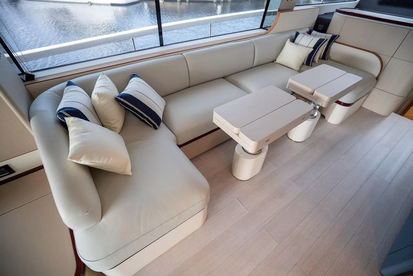 a room with a couch and a window aboard 2023 AZIMUT FLY 78/56 Yacht for Sale