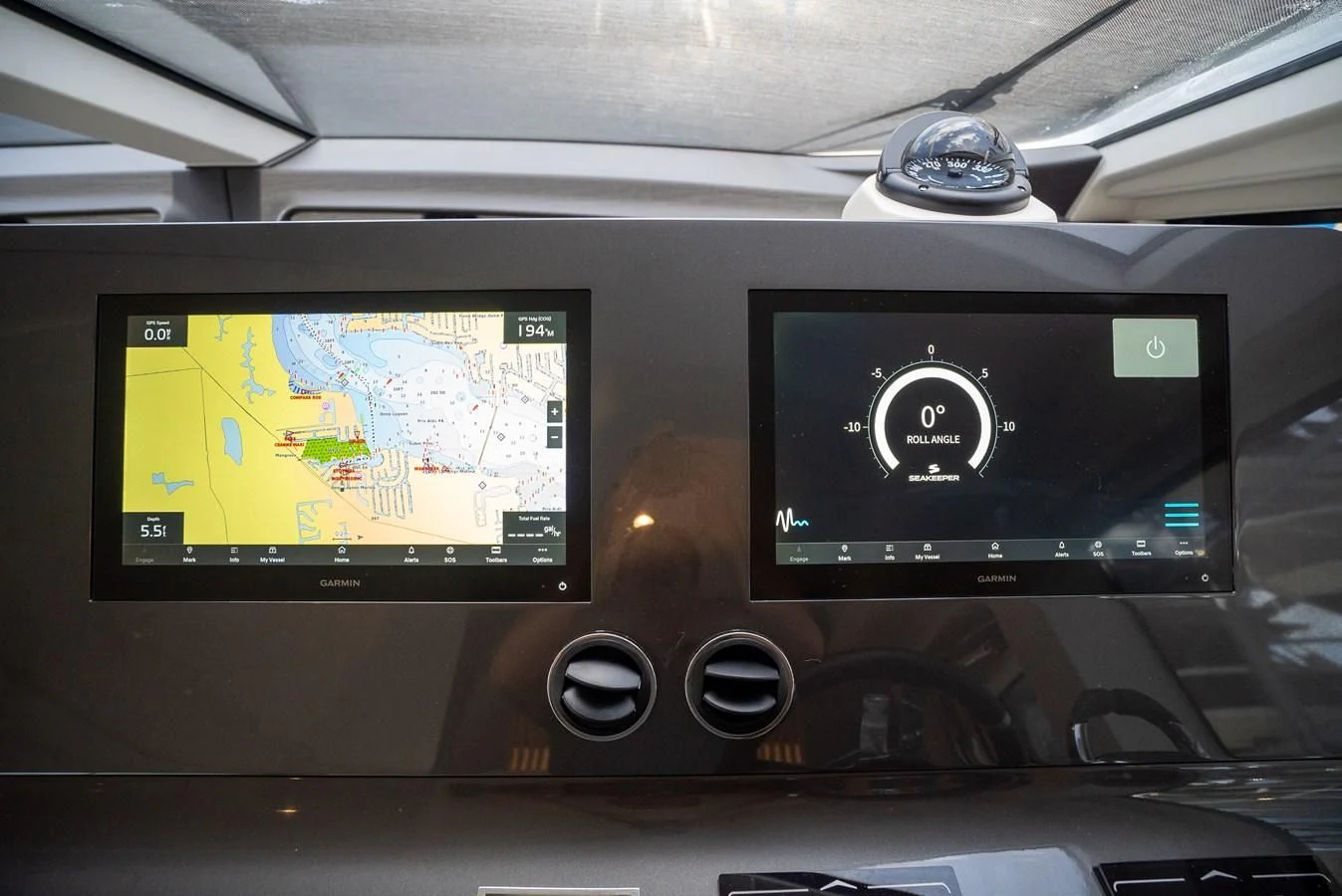a car dashboard with a screen and buttons on the side aboard 2023 AZIMUT FLY 78/56 Yacht for Sale