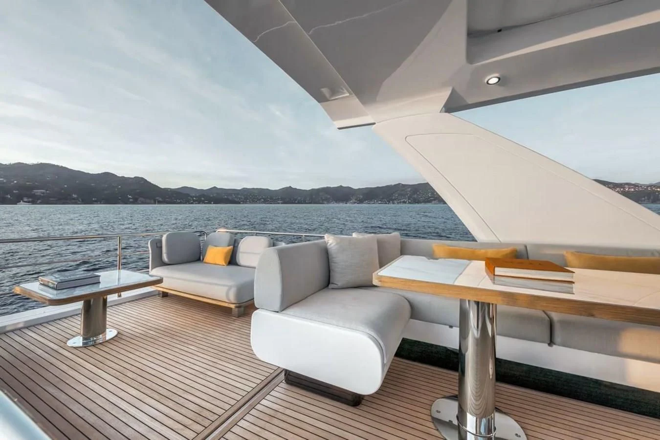 a room with a couch and a table and a large body of water aboard 2023 AZIMUT FLY 78/56 Yacht for Sale