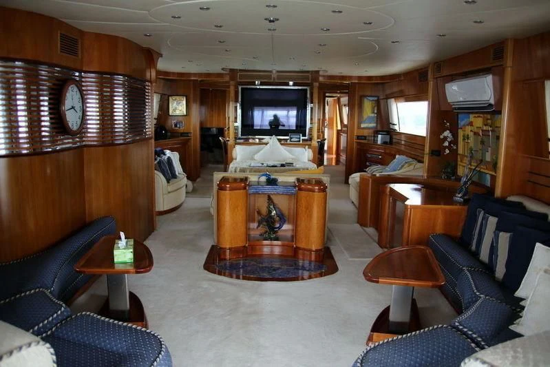a living room with a tv and furniture aboard GAMAYUN Yacht for Sale