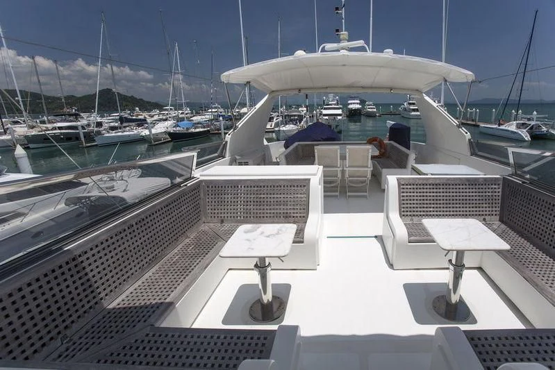 a room with a table and chairs aboard GAMAYUN Yacht for Sale