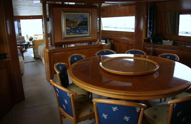 a dining table in a room aboard GAMAYUN Yacht for Sale