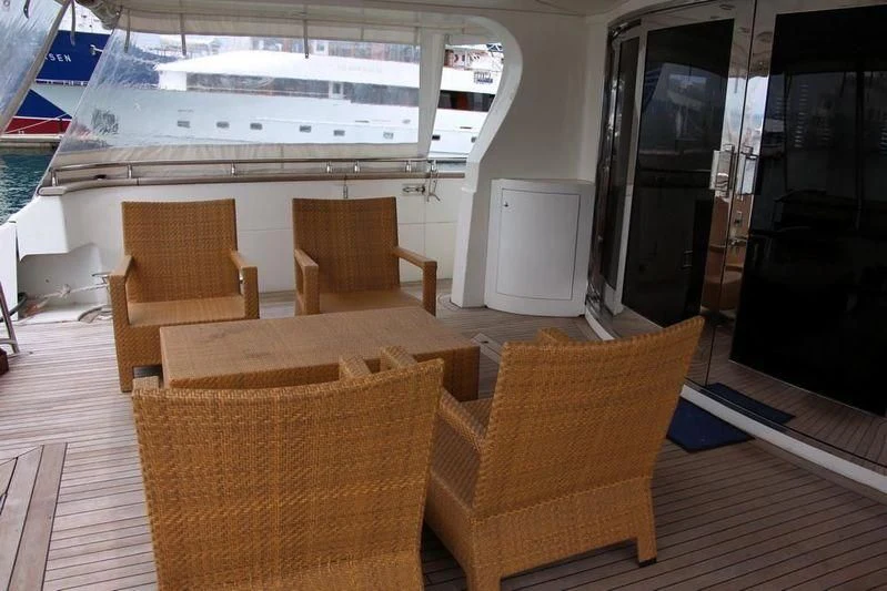 a room with chairs and a table aboard GAMAYUN Yacht for Sale