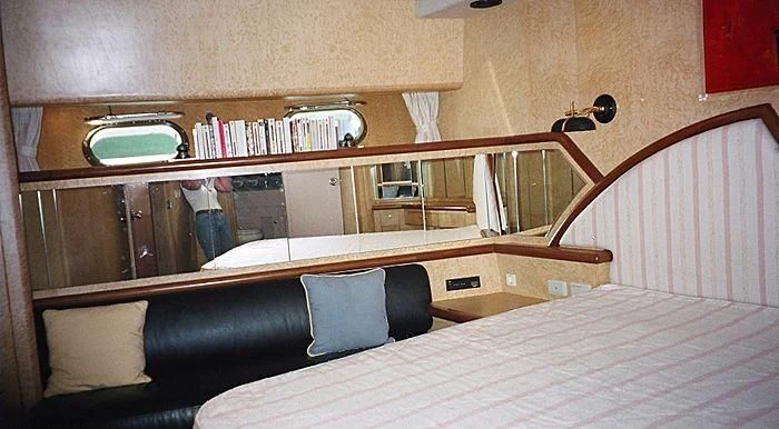 a bed with a white sheet and a white bed spread aboard ABOU MAYA Yacht for Sale