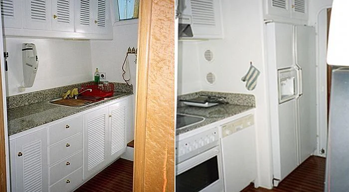 a kitchen with white cabinets aboard ABOU MAYA Yacht for Sale