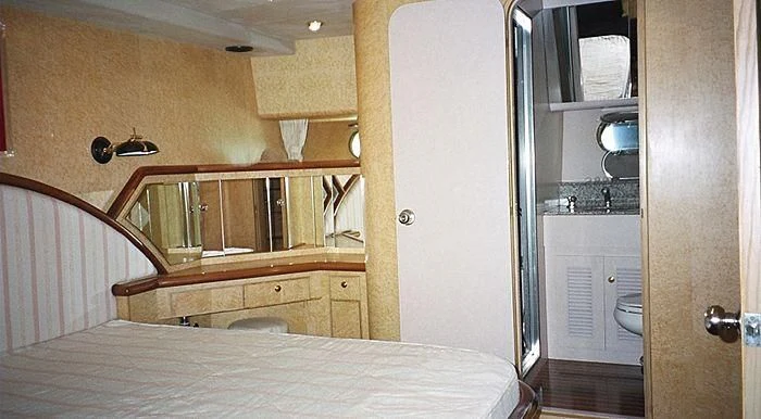 a bedroom with a bed and a closet aboard ABOU MAYA Yacht for Sale