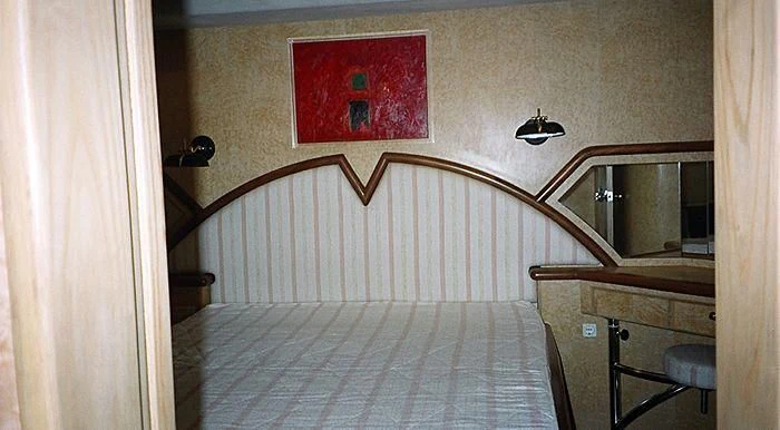 a bed with a white sheet aboard ABOU MAYA Yacht for Sale