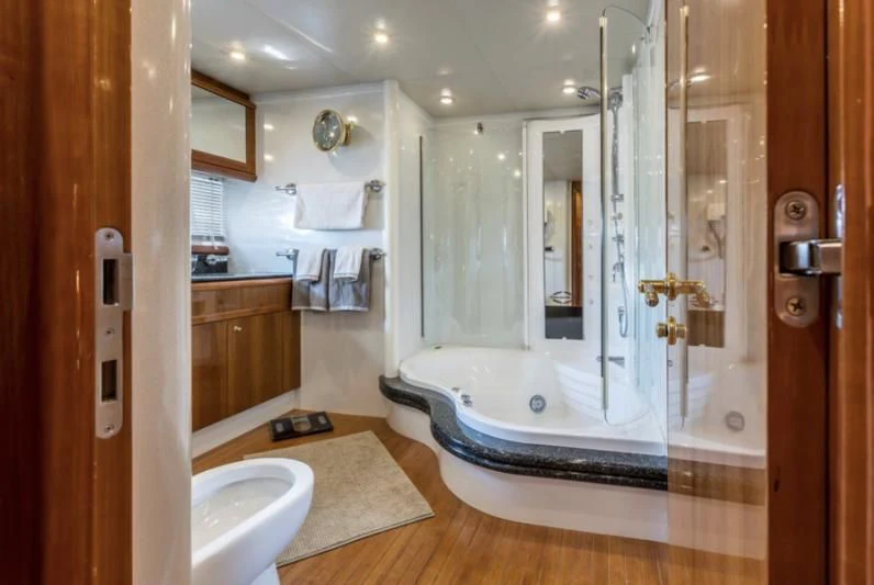 a bathroom with a glass shower aboard SKYWATER Yacht for Sale