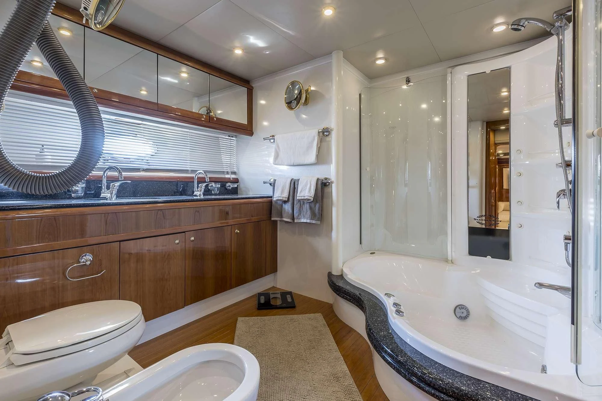 a bathroom with a tub sink and toilet aboard SKYWATER Yacht for Sale