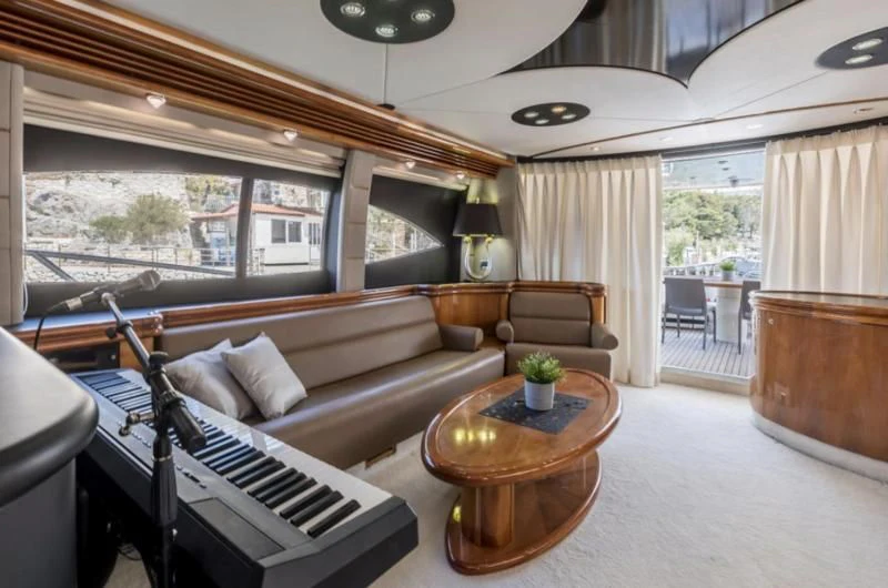 a living room with a piano aboard SKYWATER Yacht for Sale