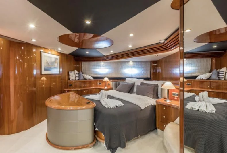 a bedroom with a bed and a wood wall aboard SKYWATER Yacht for Sale