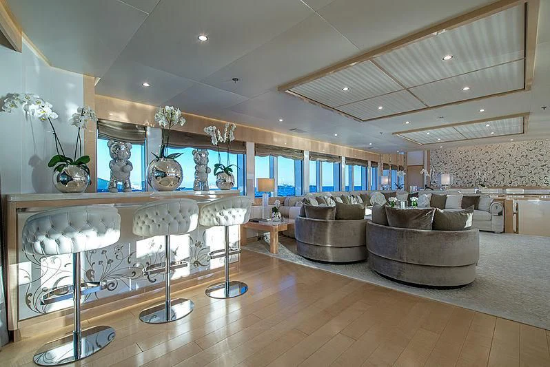 a large living room with a large chandelier aboard BLISS Yacht for Sale