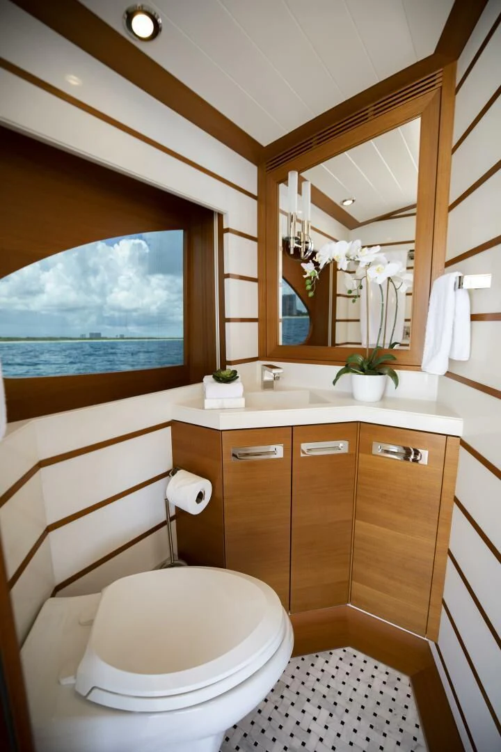 a bathroom with a large window aboard III AMIGOS Yacht for Sale