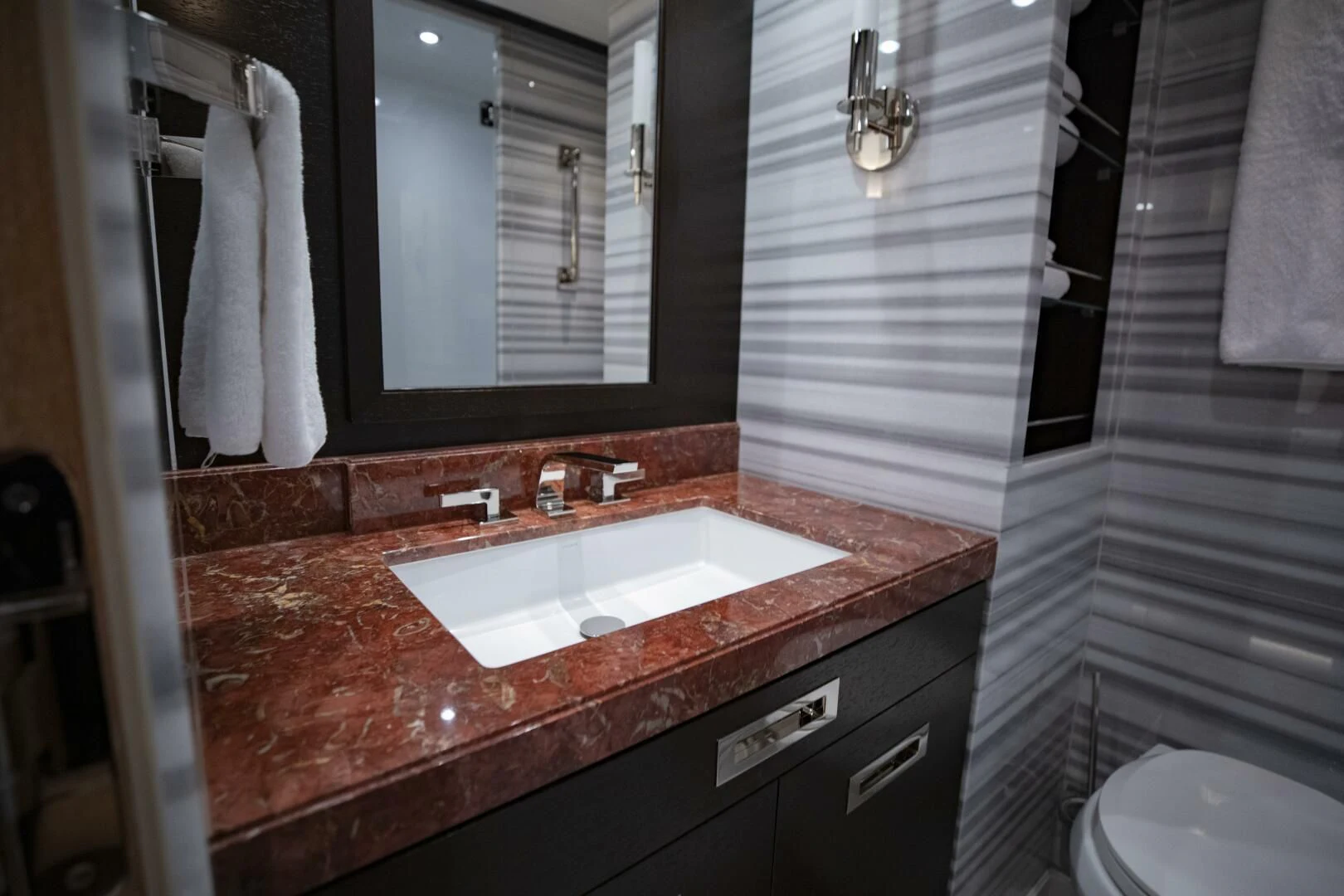 a bathroom with a sink and a mirror aboard III AMIGOS Yacht for Sale
