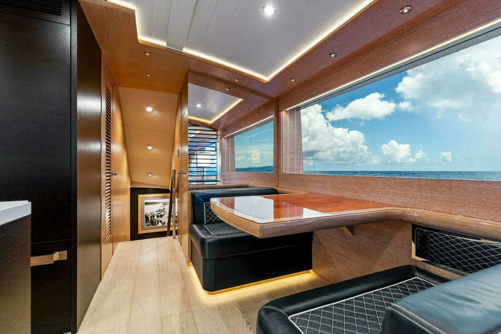 a room with a view of the ocean and the deck aboard III AMIGOS Yacht for Sale