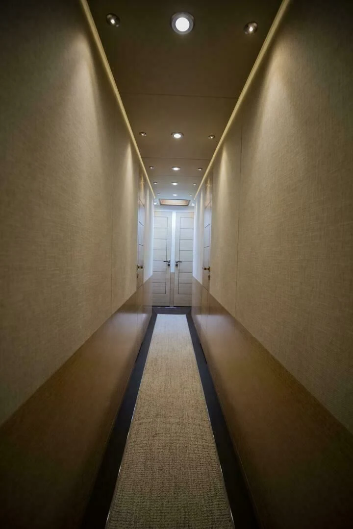 a long hallway with a row of lights aboard III AMIGOS Yacht for Sale