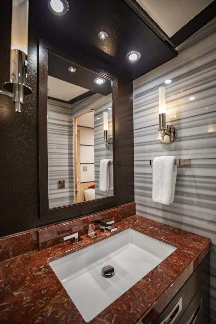 a bathroom with a large mirror aboard III AMIGOS Yacht for Sale
