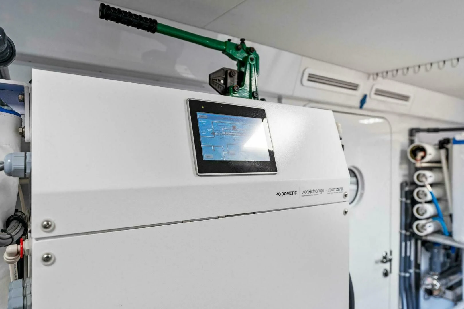 a white machine with a green tube aboard III AMIGOS Yacht for Sale