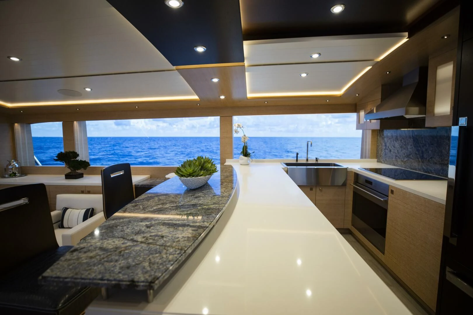 a modern kitchen with a large island aboard III AMIGOS Yacht for Sale