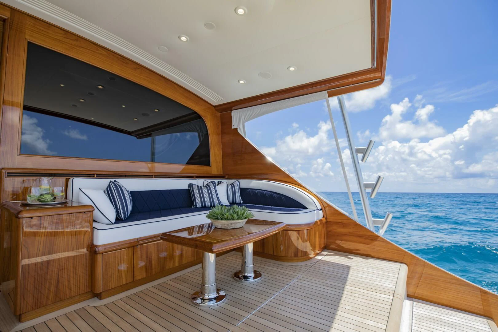 a room with a bed and a table and a window aboard III AMIGOS Yacht for Sale