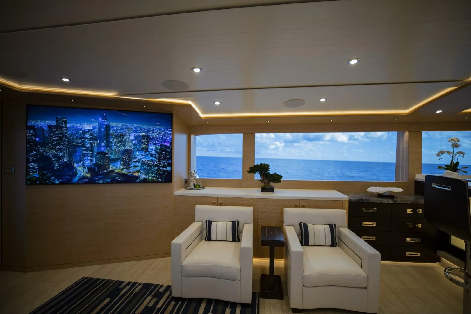 a room with a large window and a desk with a chair and a large window aboard III AMIGOS Yacht for Sale