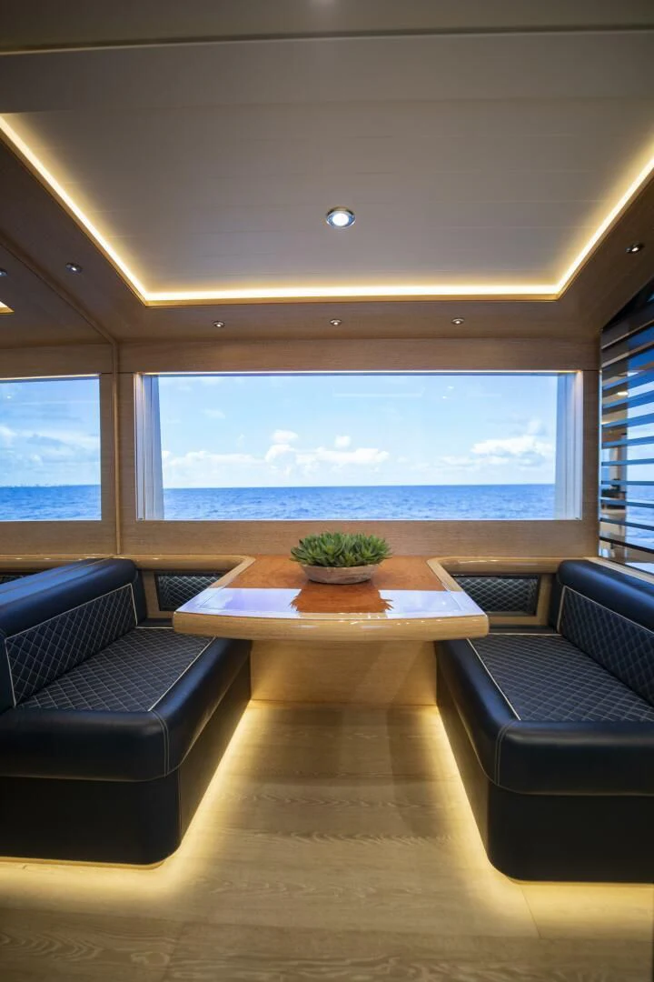 a room with a table and chairs aboard III AMIGOS Yacht for Sale