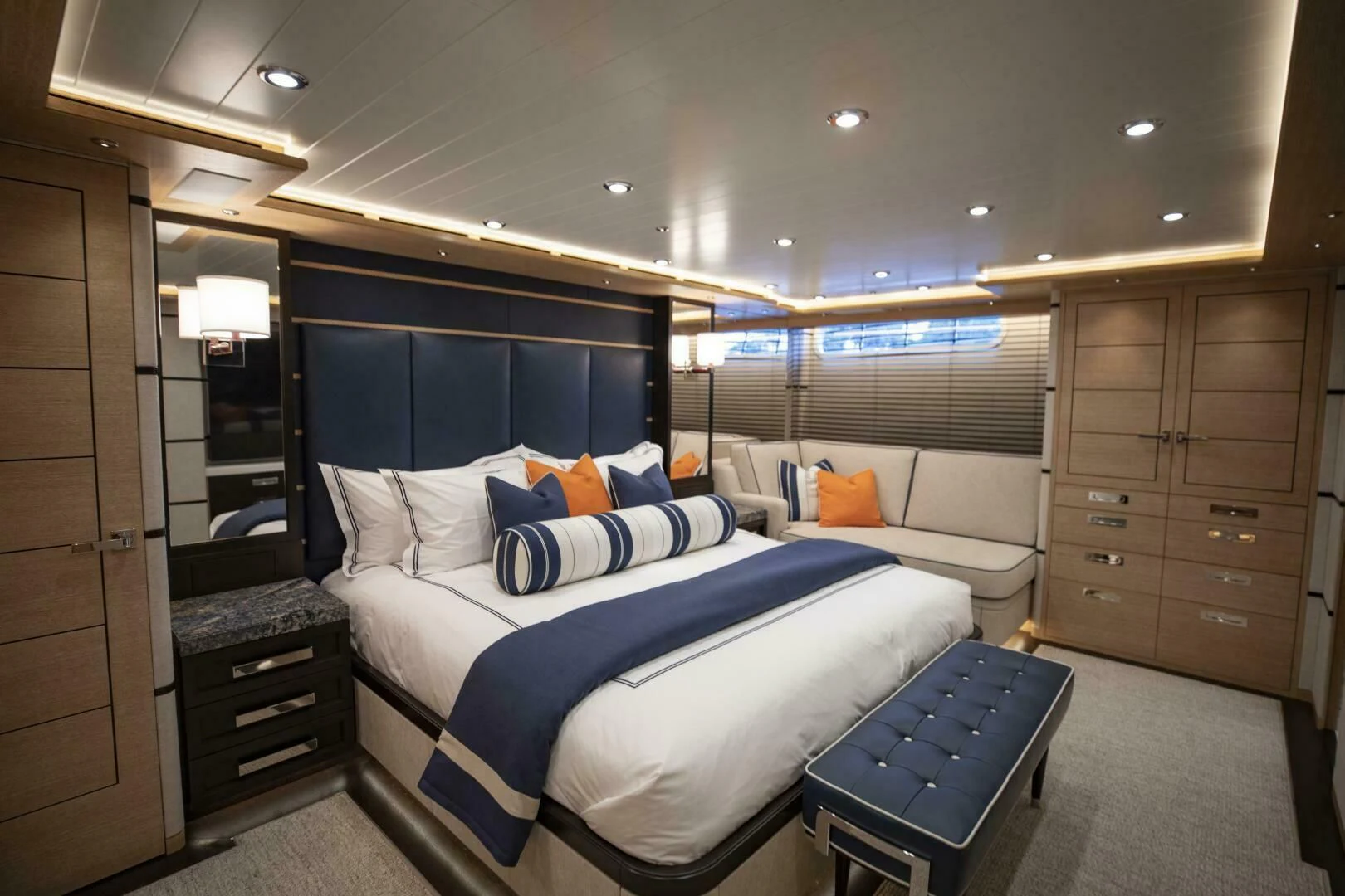 a bedroom with a bed and a couch aboard III AMIGOS Yacht for Sale