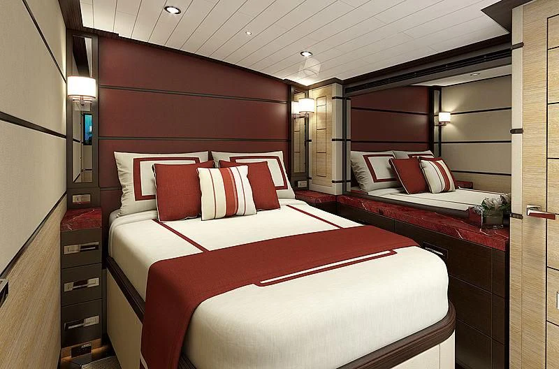 a bed with red pillows aboard III AMIGOS Yacht for Sale