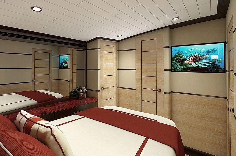 a room with a bed and a tv on the wall aboard III AMIGOS Yacht for Sale
