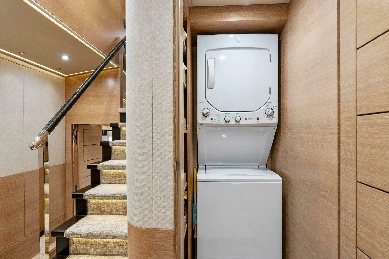 a bathroom with a washer and dryer aboard III AMIGOS Yacht for Sale