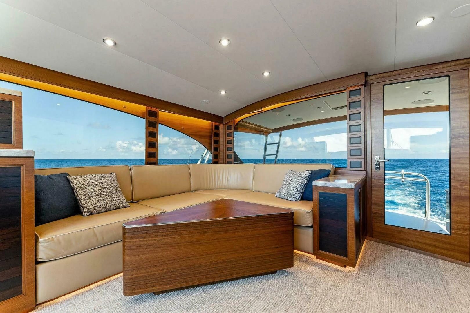 a living room with a couch and a large window aboard III AMIGOS Yacht for Sale