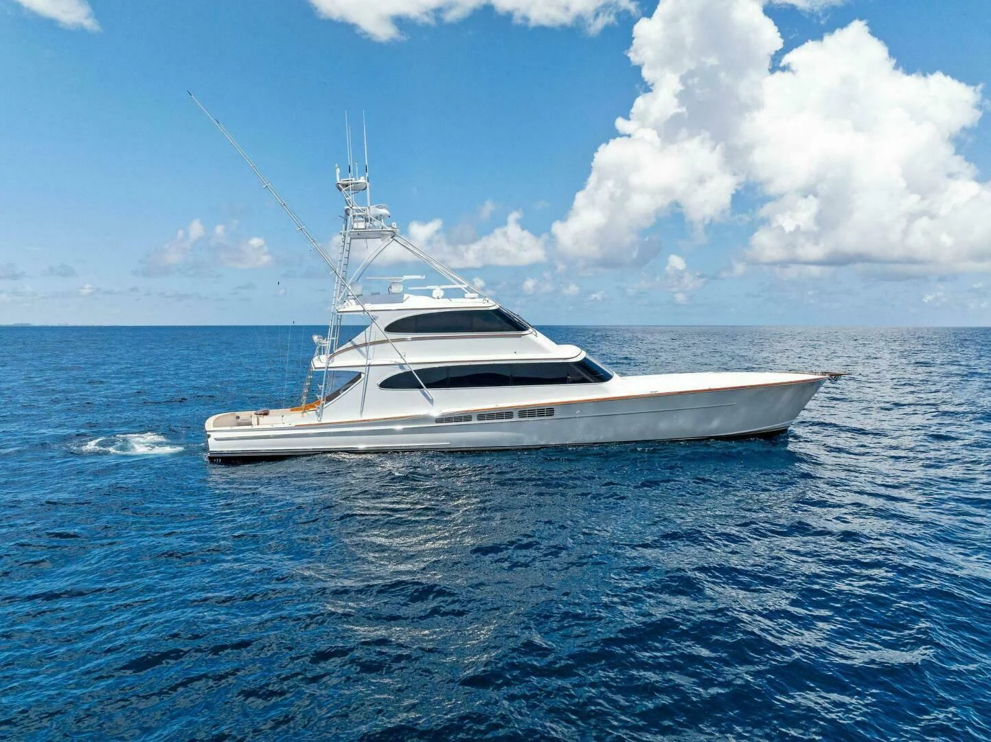 a white yacht in the water aboard III AMIGOS Yacht for Sale
