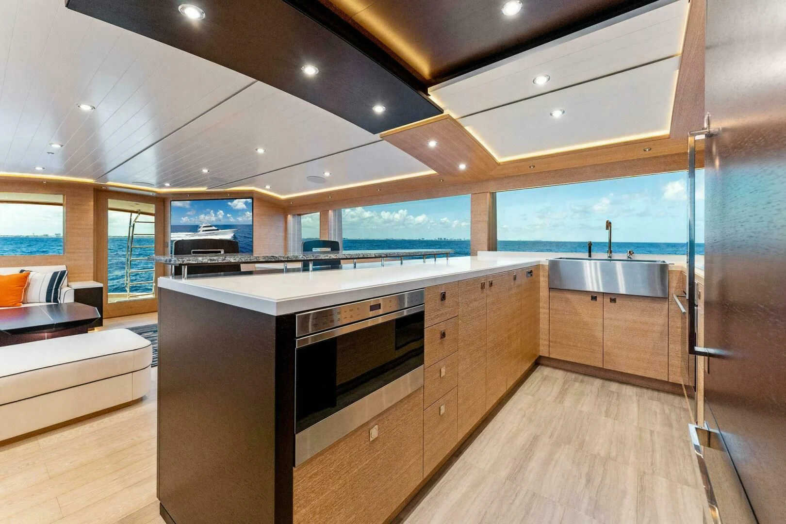 a kitchen with a large glass wall aboard III AMIGOS Yacht for Sale
