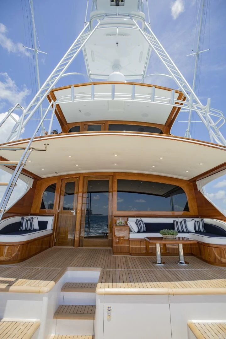 a large white boat on a wooden deck aboard III AMIGOS Yacht for Sale