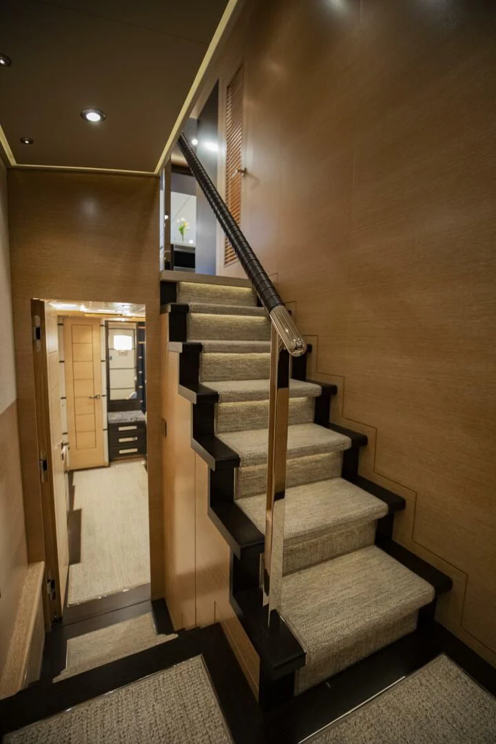 a wood staircase in a room aboard III AMIGOS Yacht for Sale