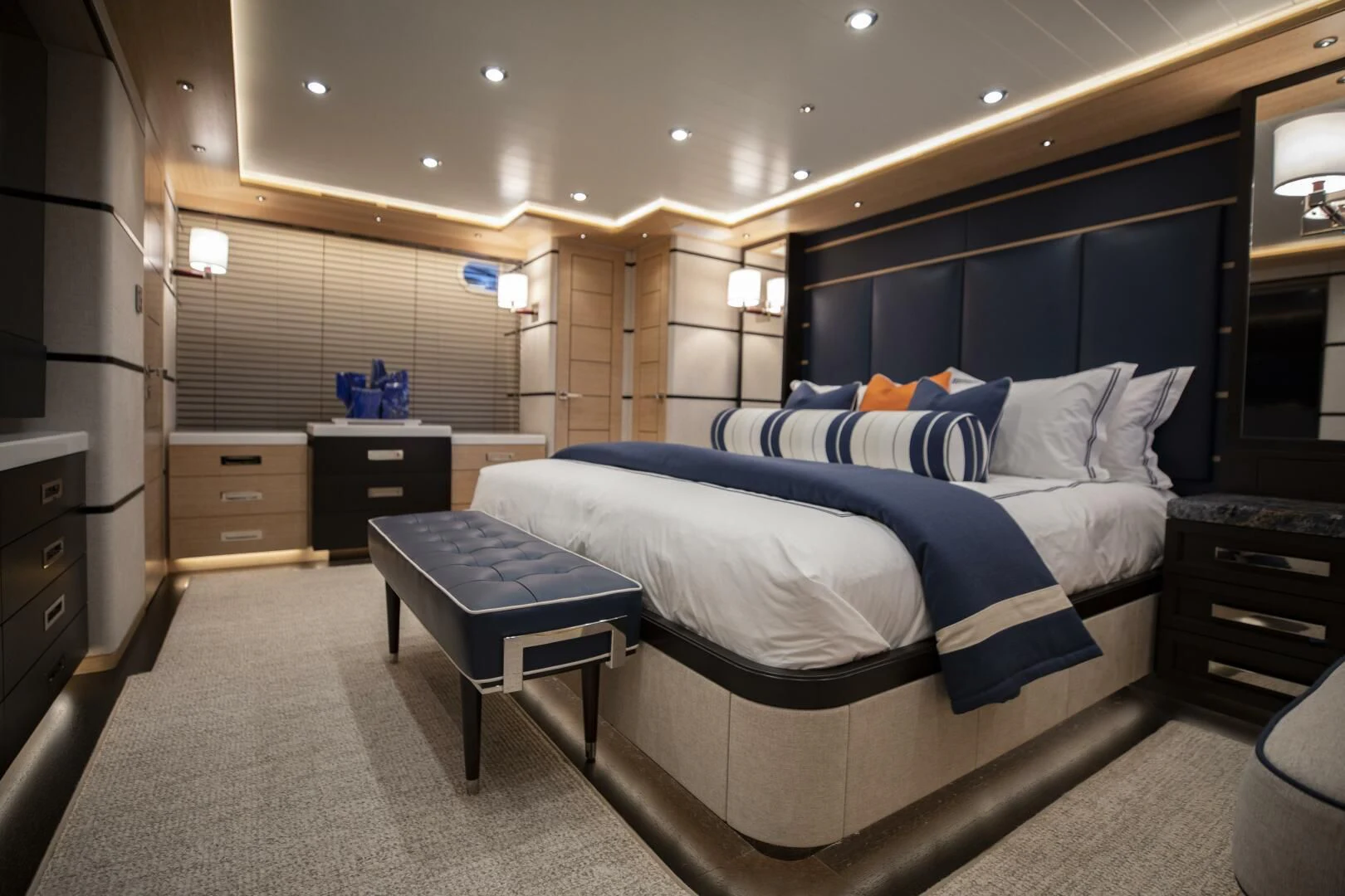 a bedroom with a bed and desk aboard III AMIGOS Yacht for Sale