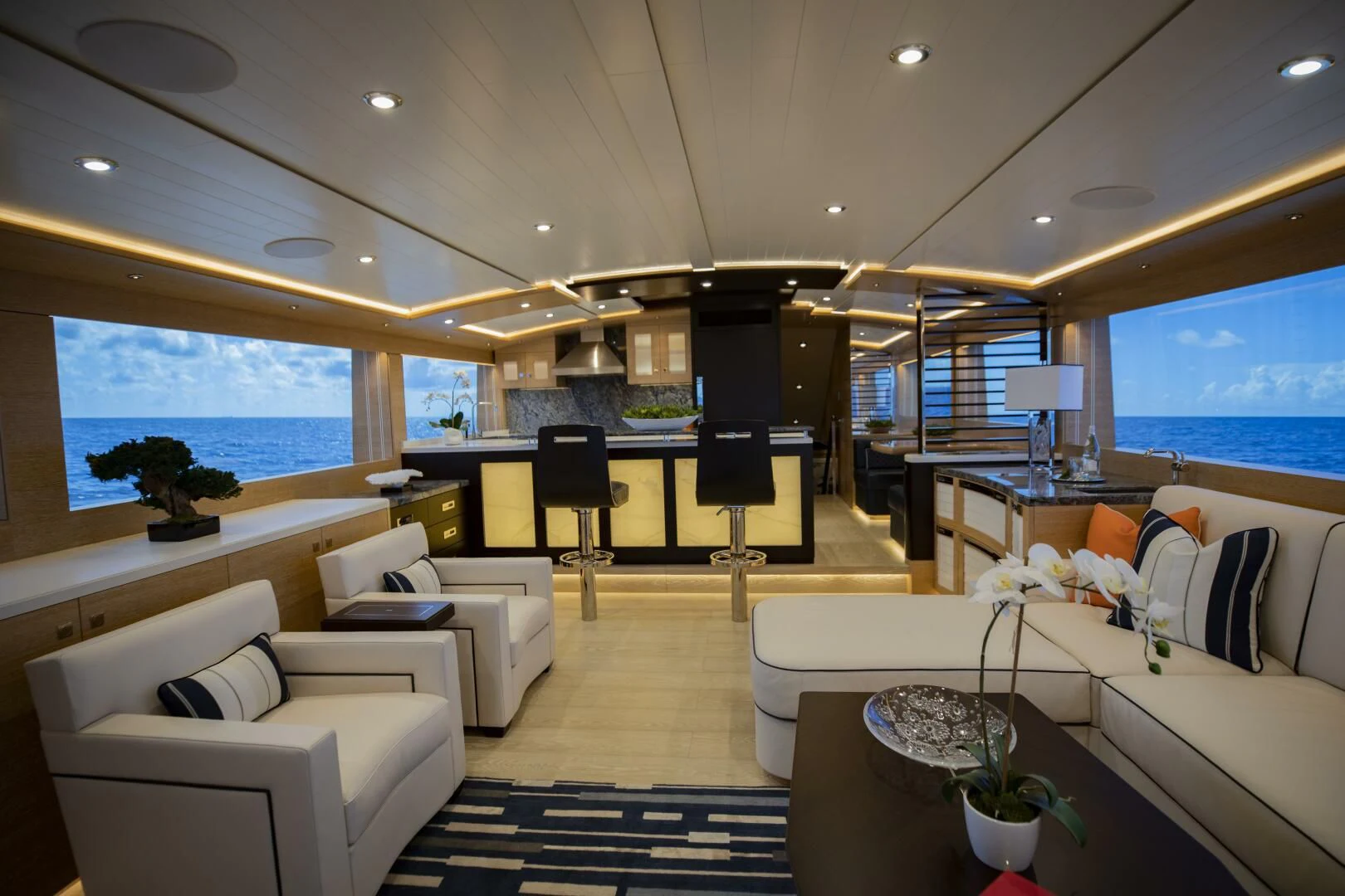a room with a couch and a table and a tv aboard III AMIGOS Yacht for Sale