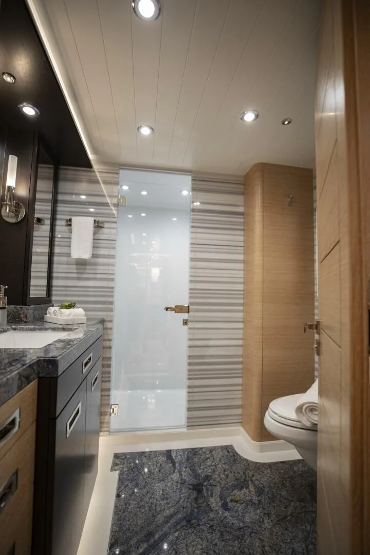 a bathroom with a shower and sink aboard III AMIGOS Yacht for Sale