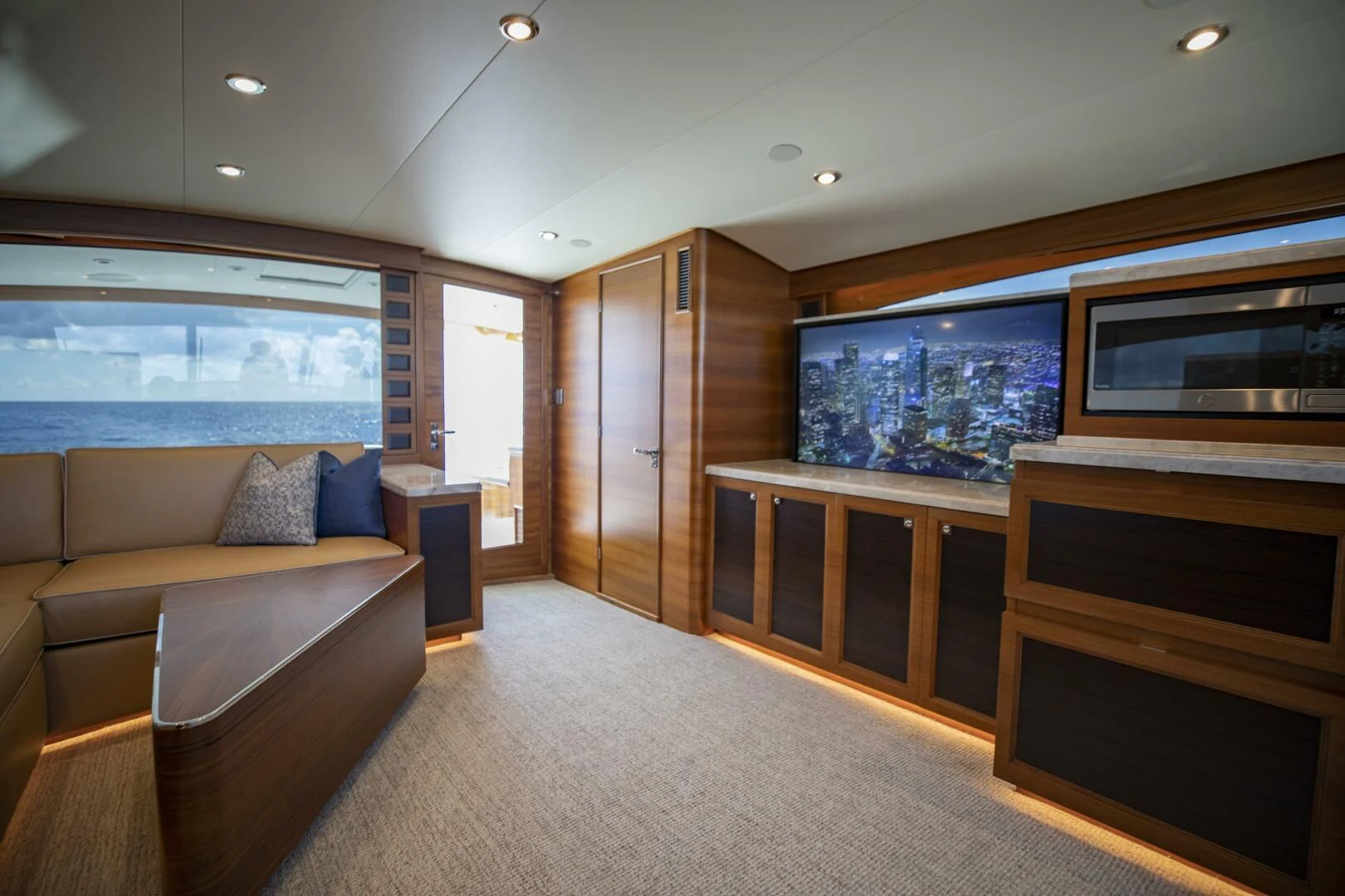 a living room with a couch and a tv aboard III AMIGOS Yacht for Sale