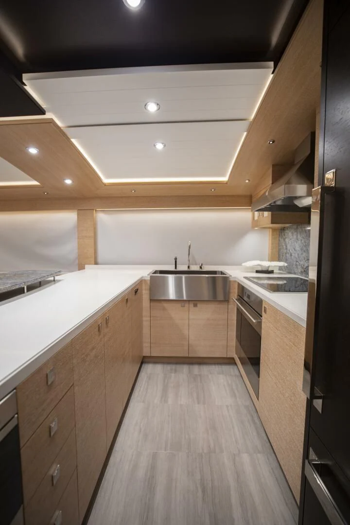 a kitchen with a wood floor aboard III AMIGOS Yacht for Sale