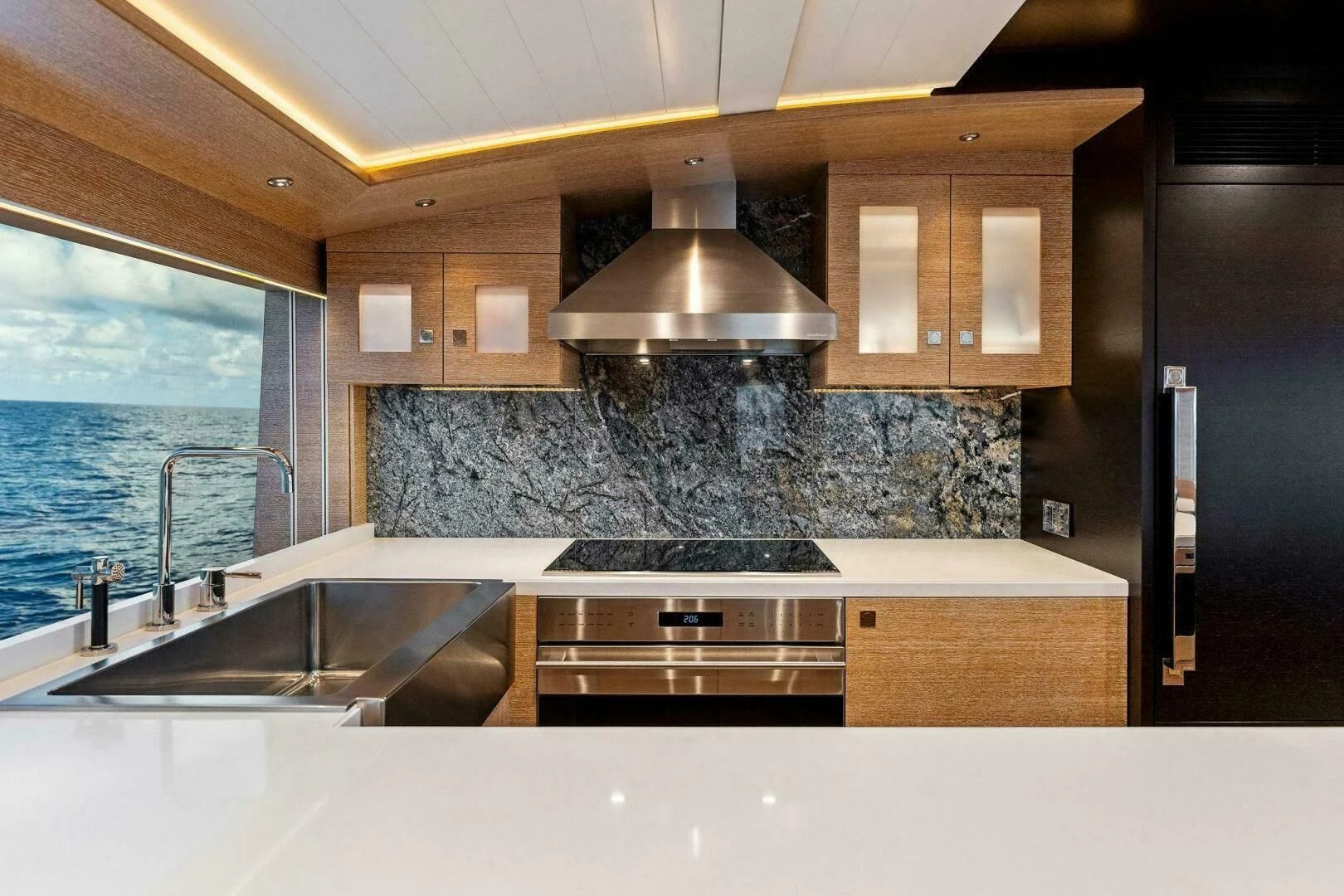 a kitchen with a large stone wall aboard III AMIGOS Yacht for Sale