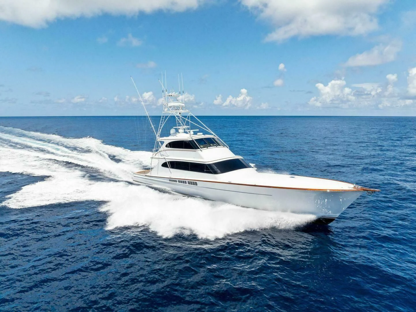 a white yacht on the water aboard III AMIGOS Yacht for Sale