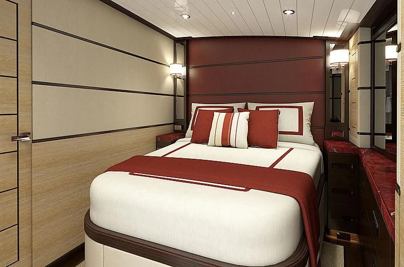 a bed with red pillows aboard III AMIGOS Yacht for Sale