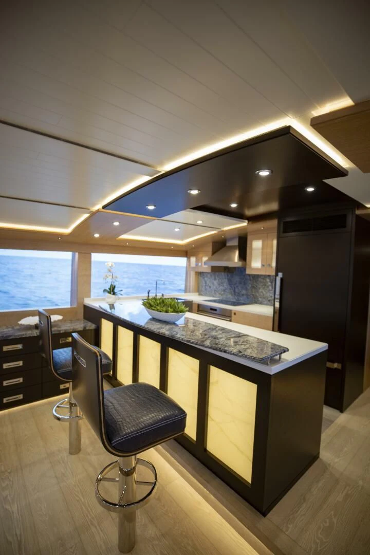 a kitchen with a large island aboard III AMIGOS Yacht for Sale