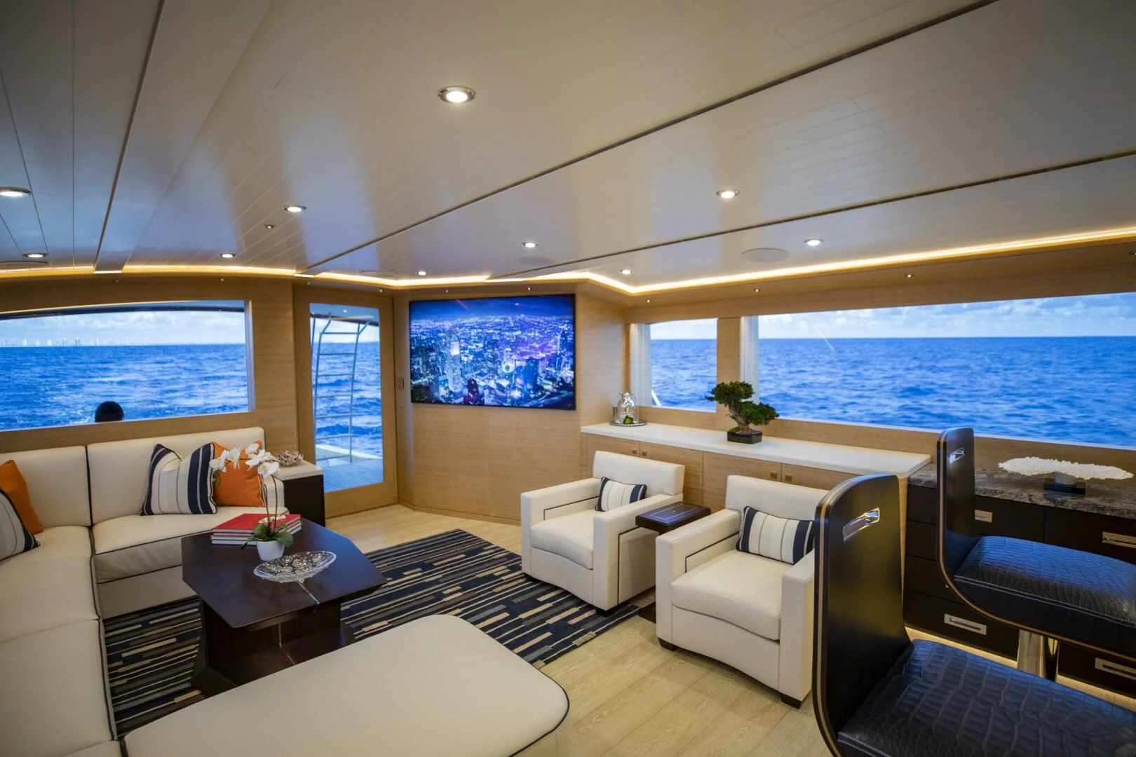 a living room with a large window aboard III AMIGOS Yacht for Sale
