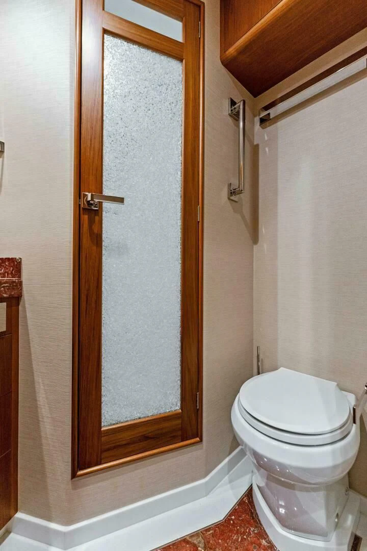 a bathroom with a toilet aboard III AMIGOS Yacht for Sale