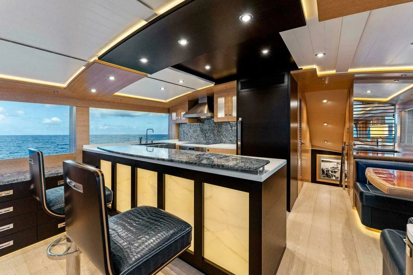 a kitchen with a bar and a bar aboard III AMIGOS Yacht for Sale